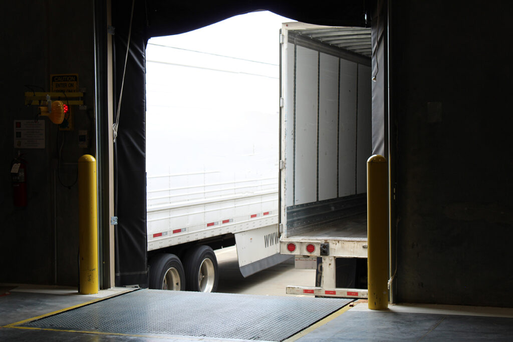 truck backing up to warehouse dock door